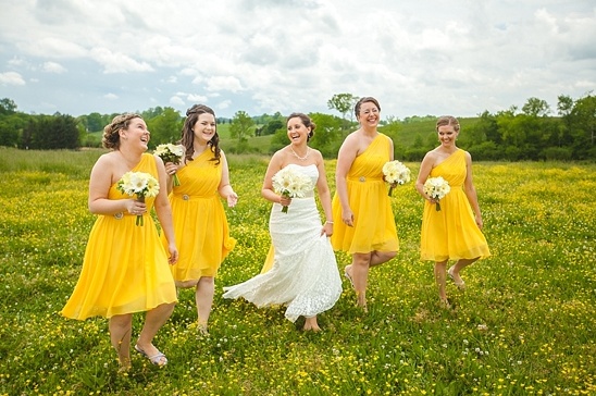 Bride and bridesmaids in yellow dresses in field