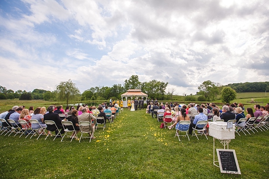 Outdoor wedding ceremony with gazebo and many guests