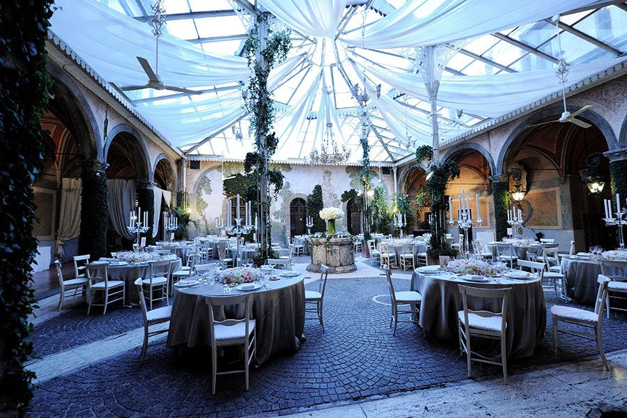 Elegant wedding reception venue with draped ceiling and tables