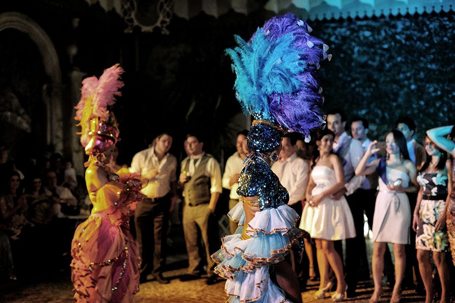 Dancers in vibrant costumes entertain at a lively party or event