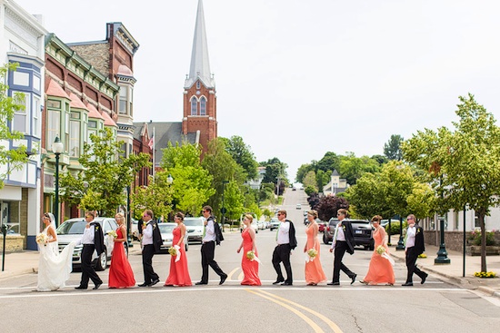 Wedding party crossing street in small town