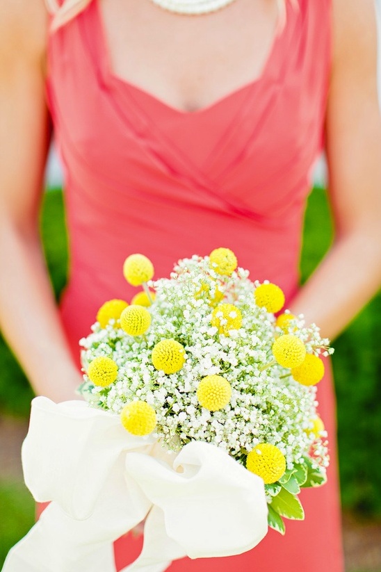 Bridesmaid holds yellow craspedia flower bouquet