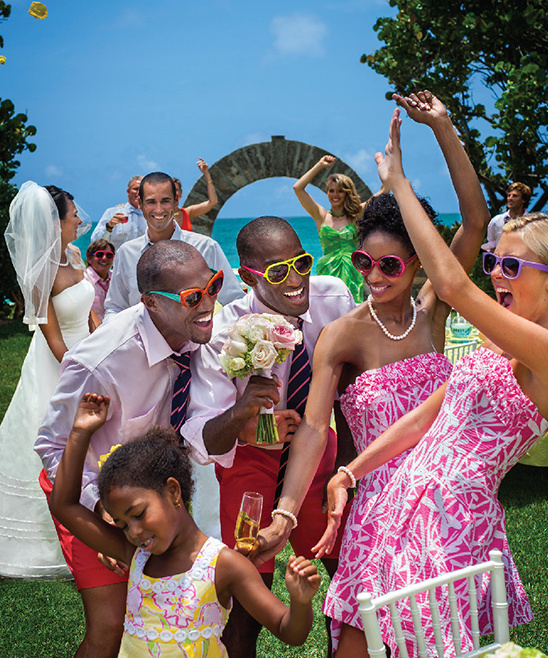 Joyful wedding celebration with dancing guests and bride and groom