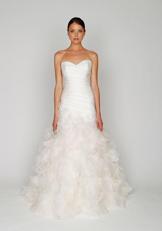 Elegant strapless wedding dress with ruffled skirt and a beautiful bride