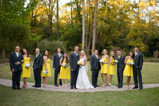 Wedding party in yellow dresses and gray suits outdoors