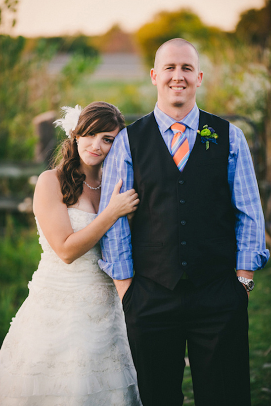Happy couple embracing at their wedding, in a sunny day