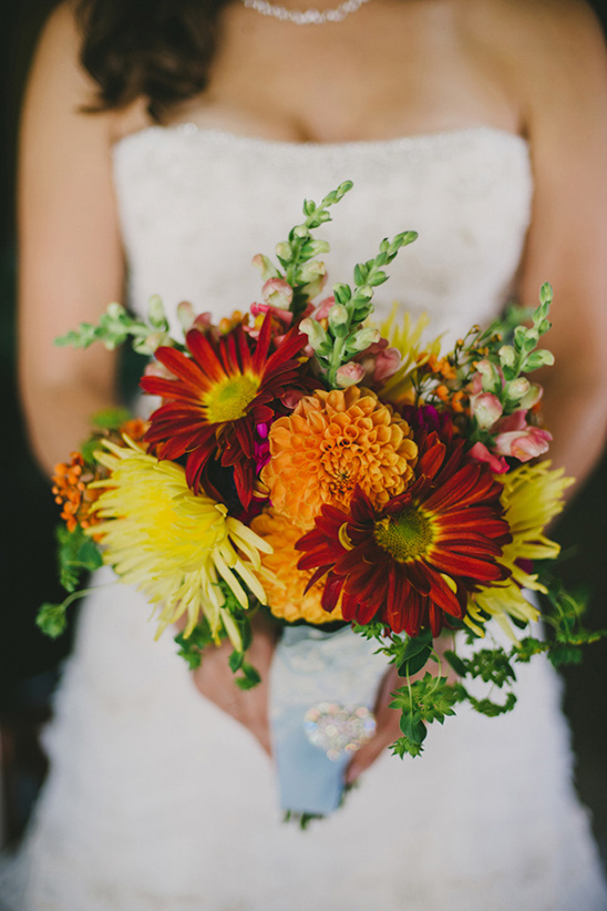 Bride holding a beautiful vibrant bouquet of colorful flowers