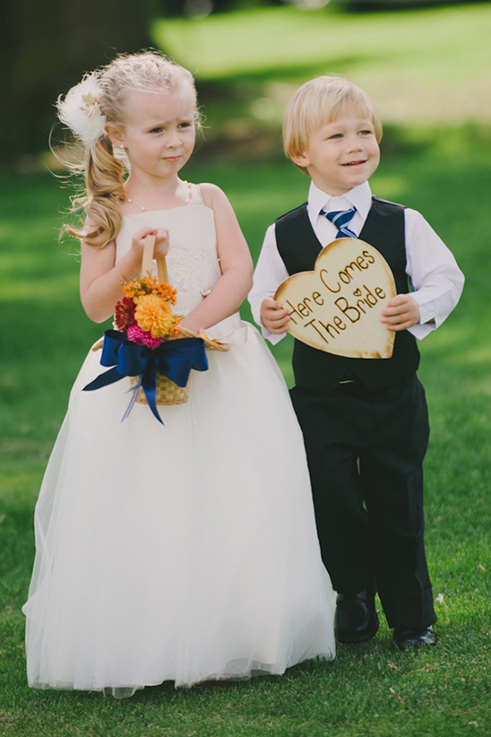 Adorable flower girl and ring bearer at an outdoor wedding ceremony