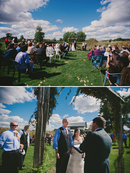 Outdoor wedding ceremony with guests and couple under blue sky