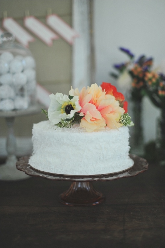 simple white wedding cake with floral decoration