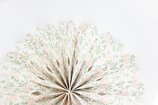 Floral paper fan with delicate peach and green pattern