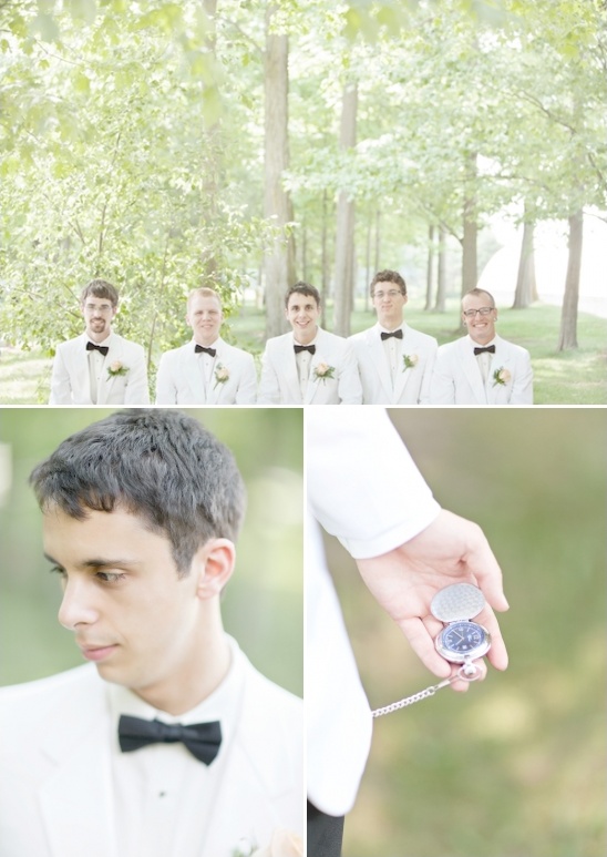 Wedding photo of groomsmen in white suits with black bow ties