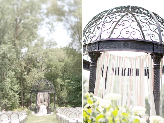 Romantic outdoor wedding ceremony with gazebo and ribbons