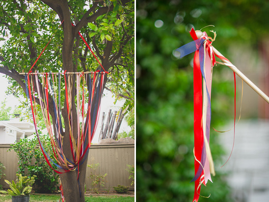 Tree decorated with colorful ribbons for a festive outdoor event