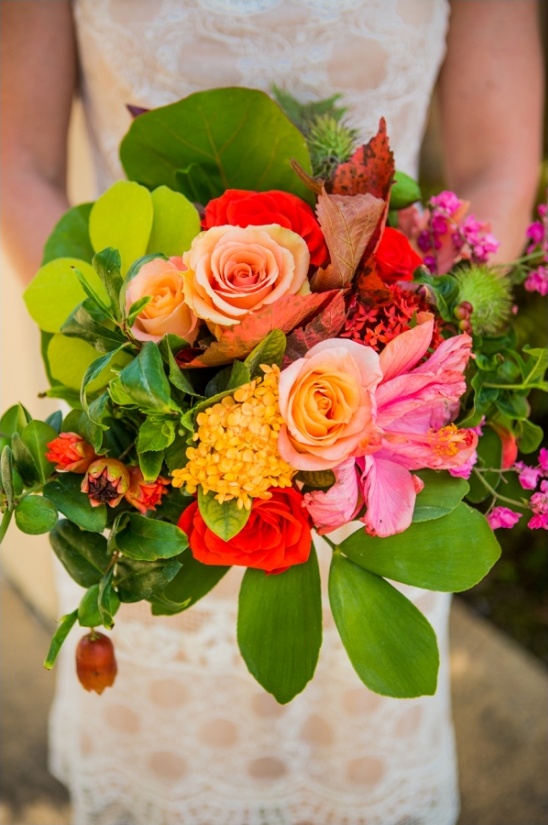 Beautiful bride holding a colorful vibrant bouquet of flowers