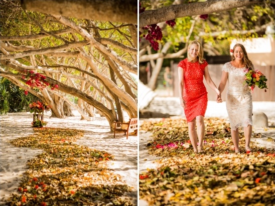 Two women walking down a leaf-strewn path for their wedding