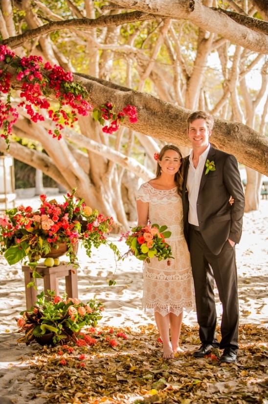 Beautiful couple on a beach wedding with floral decorations