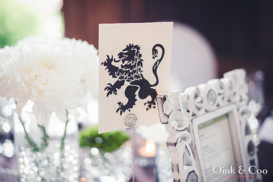 Elegant lion emblem on a table setting with white flowers and decor