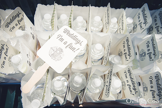 Wedding favors with water bottles and fans for guests