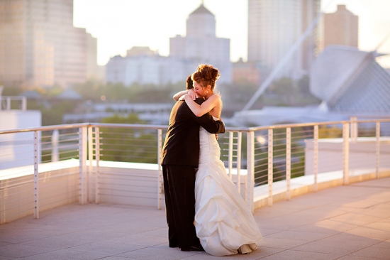 Bride and groom embrace on a balcony, a tender wedding moment