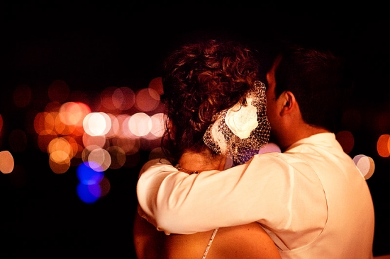 Couple embracing with bokeh lights in the background