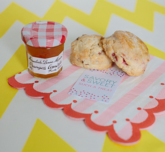Scones with jam, sweet treat on a pink and white striped napkin