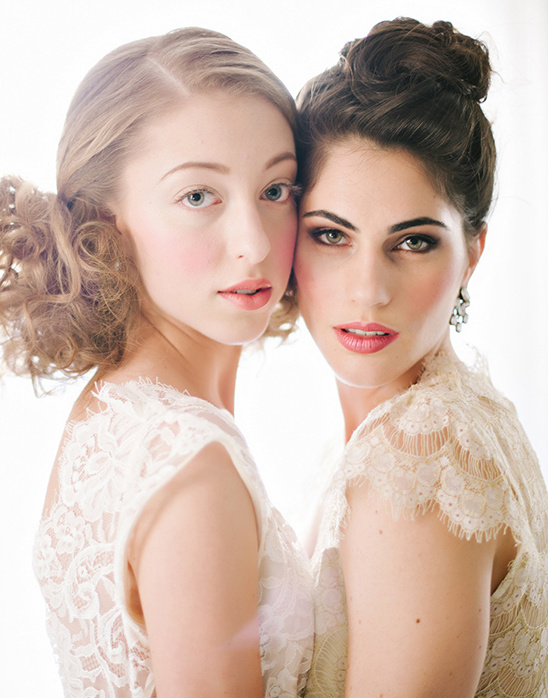 Two beautiful women in lace dresses, looking at the camera
