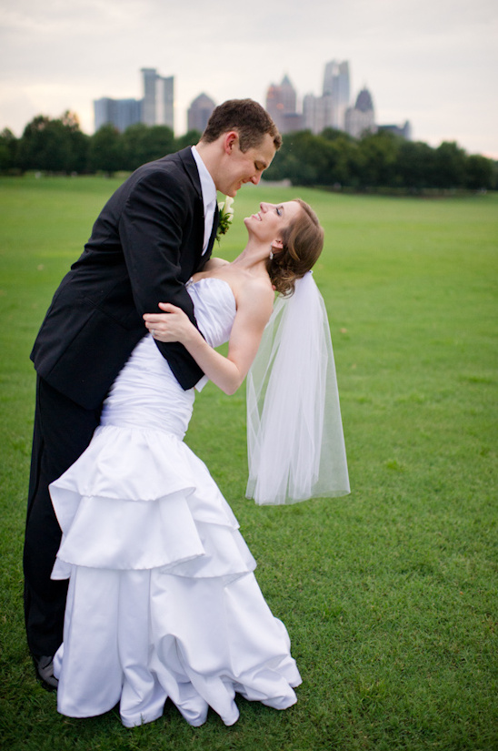 Newlyweds share a loving moment outdoors on their wedding day