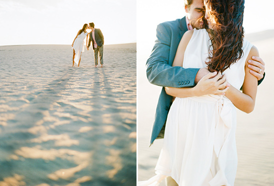 Romantic couple kissing on a sandy beach with a warm sunset glow