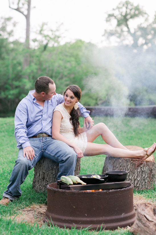 Couple enjoying a romantic campfire and cooking together outdoors