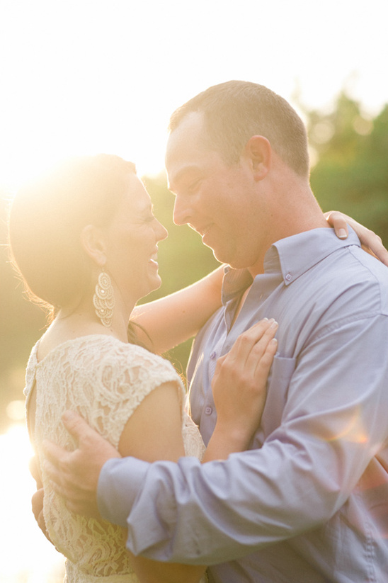 Couple embracing in soft sunlight looking at each other with love