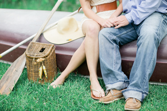 Couple enjoying a day near a boat on green grass together