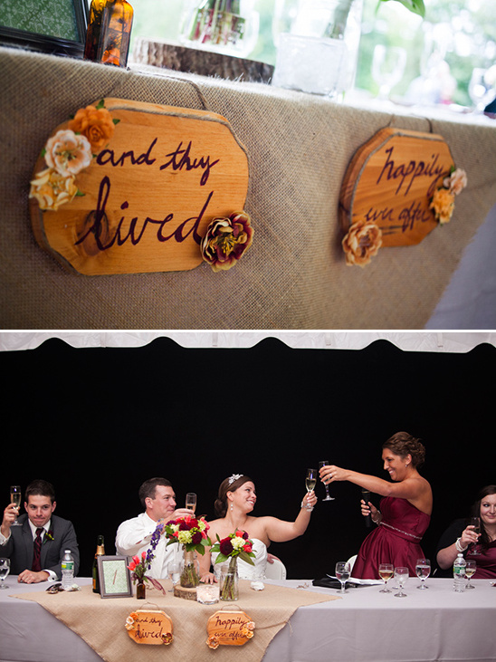 Rustic wedding reception with wooden signs and toast
