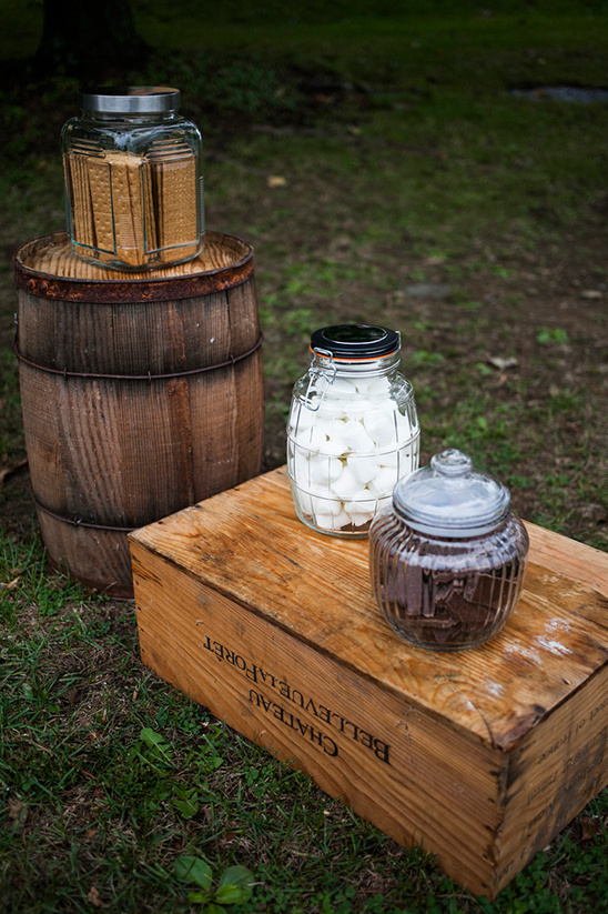 Vintage candy jars on rustic wooden barrel and box