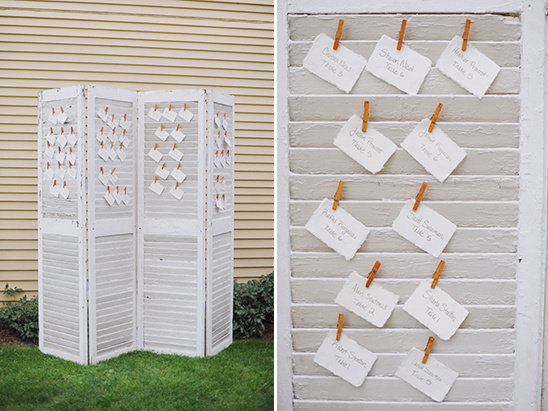 Wedding seating chart on a white screen with clothespin display