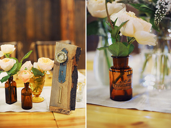 Rustic wedding table decor with flowers and unique number sign