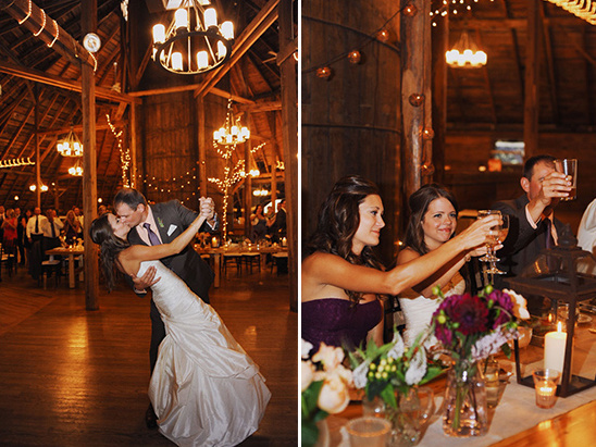 Bride and groom share a kiss during a wedding dance in a barn