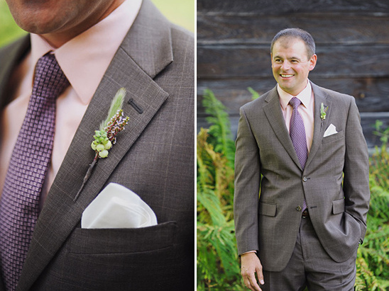 Groom wearing a gray suit with a pink shirt and purple tie