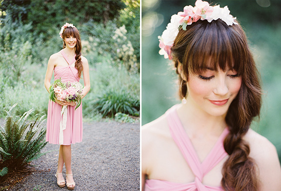 Bride with a flower crown wearing a pink dress and holding flowers