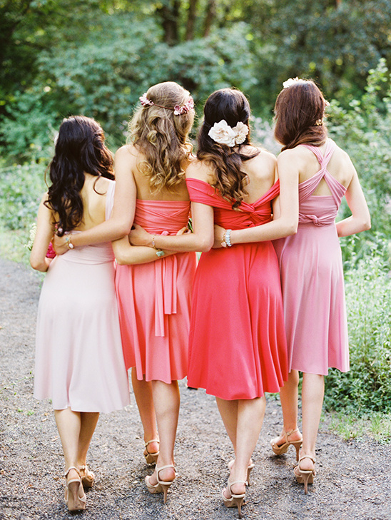 Bridesmaids in pink dresses walking towards the camera