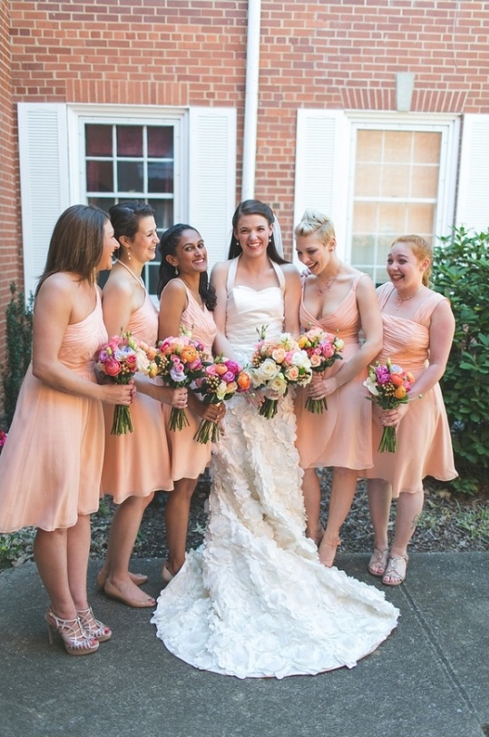 peach bridesmaid dresses and colorful bouquets