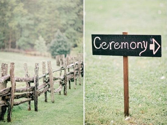 Rustic wedding ceremony sign pointing the way near an old fence