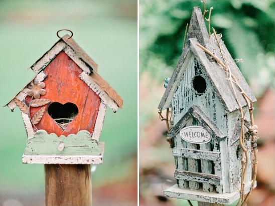 Two rustic, charming birdhouses on a wooden post and shelf