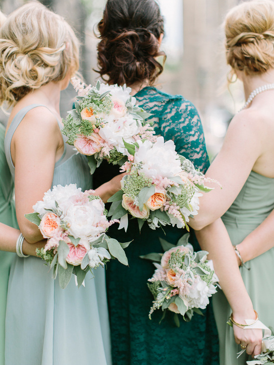 Bridesmaids holding bouquets at a wedding in spring colors