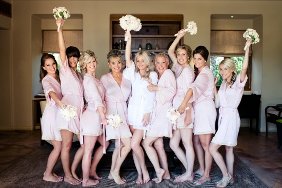 Bridesmaids in pink robes with bouquets