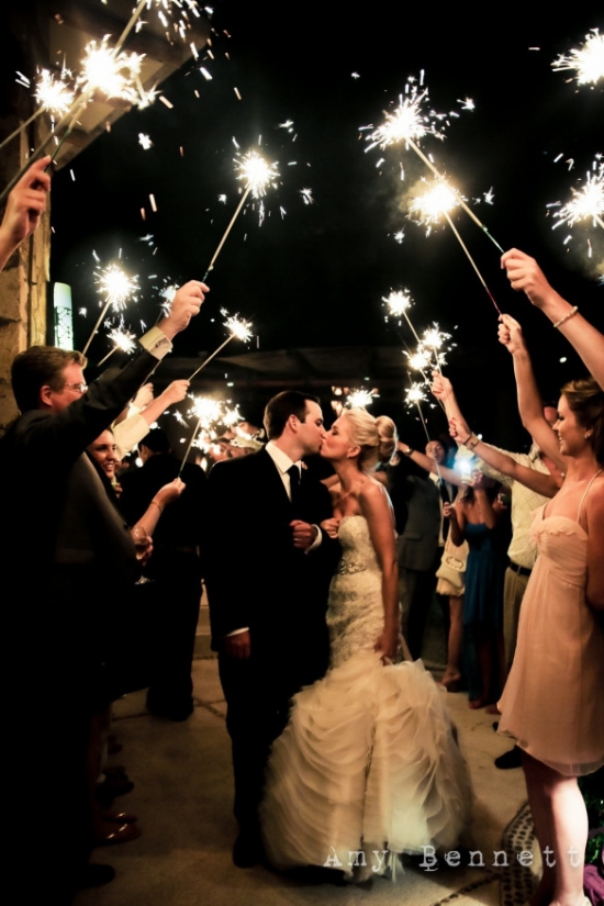 Wedding couple kissing sparklers night
