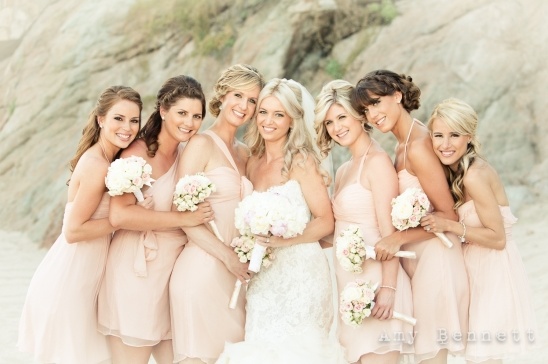 Happy bridesmaids in blush dresses