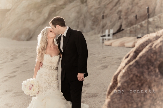 Couple kissing beach wedding bliss