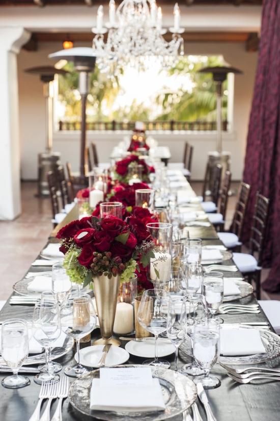 Elegant wedding reception table setting with red roses