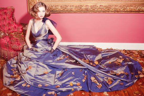 Woman in blue gown with autumn leaves fashion shot